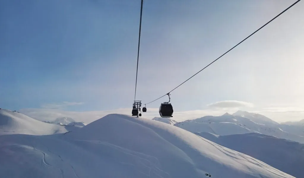 Gondolskiheis høyt over fjellene om vinteren i et skiområde i Østerrike