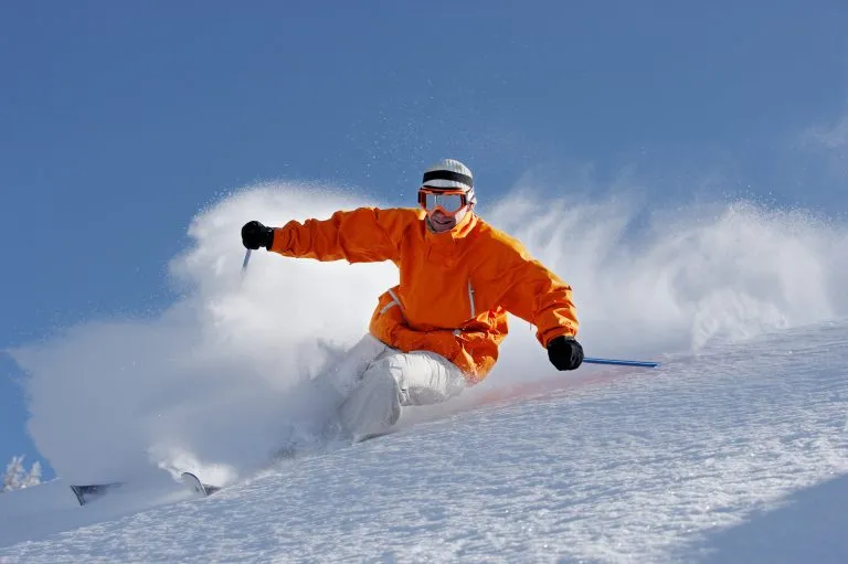 Man wearing goggles skiing